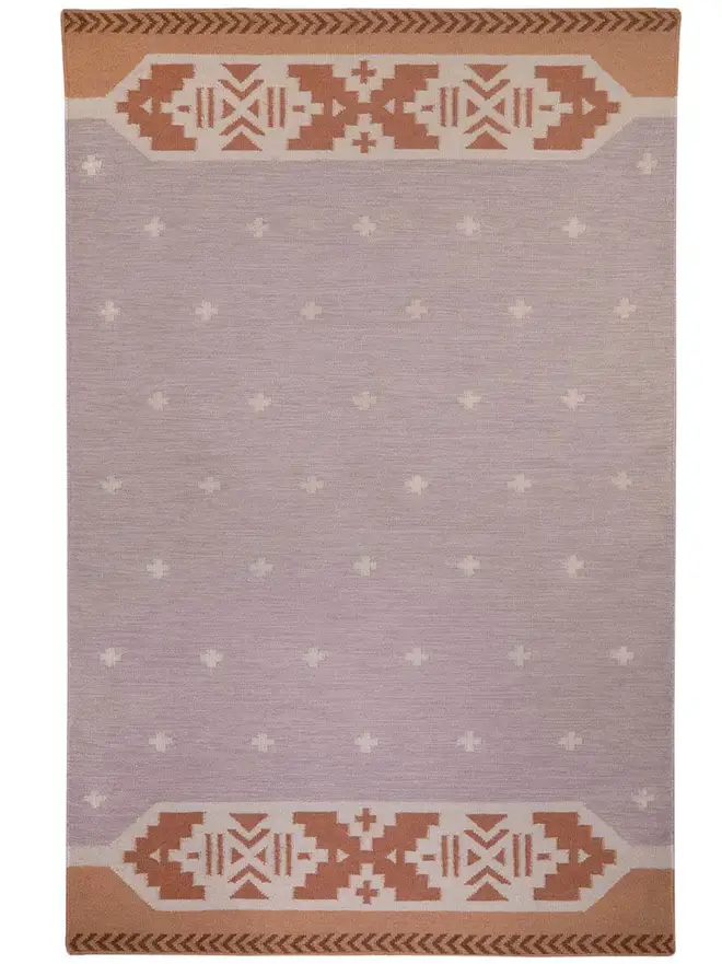 Manali Flatweave Rug, a colourful rug sitting on a plain surface. 