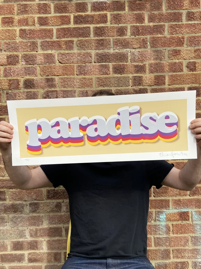  "Paradise" Cream Handpulled Screenprint rectangular with cream background and the word paradise printed on top in rainbow letters includes a drop shadow 