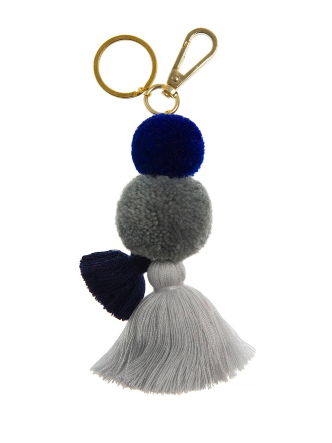 pom pom and tassel keyring. a keyring with grey and purple pom poms. 
