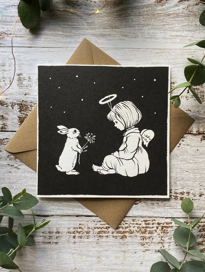 a bunny and angel featured on a christmas greeting card