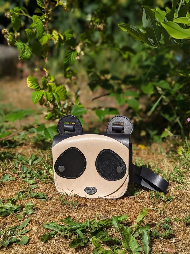 Handmade leather Panda cross- body bag, viewed from the front. 