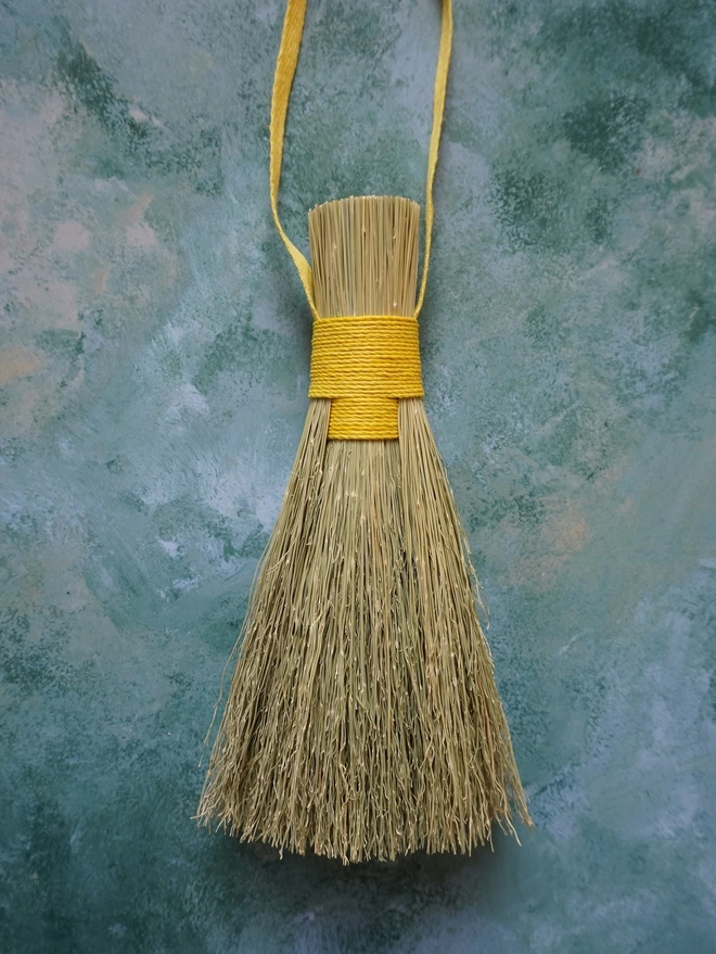Handmade broomcorn bundle brush with yellow hemp cord binding