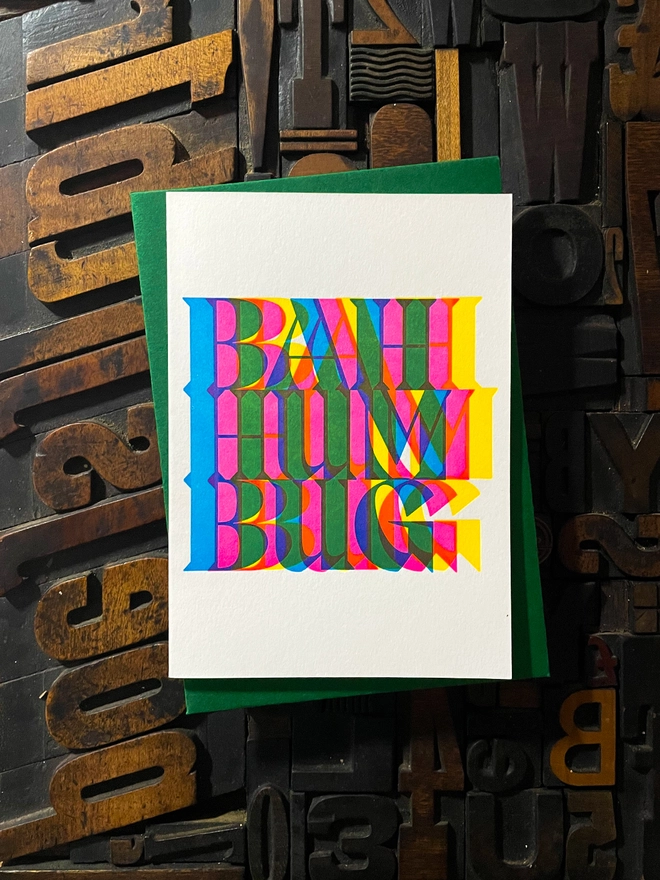 Bah Humbug! A beautiful typographic letterpress Christmas card set. Printed with rich vibrant and fluorescent blue, magenta and yellow inks with luxury matching and contrasting envelopes; ideal to send to your designer friends.