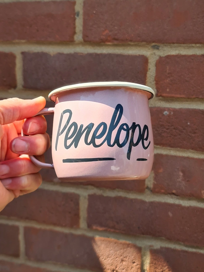 Pink mug with dark grey text