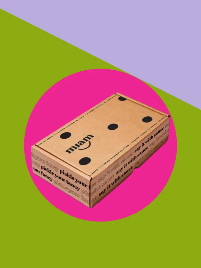 giftbox on a green and purple background with a pink circle