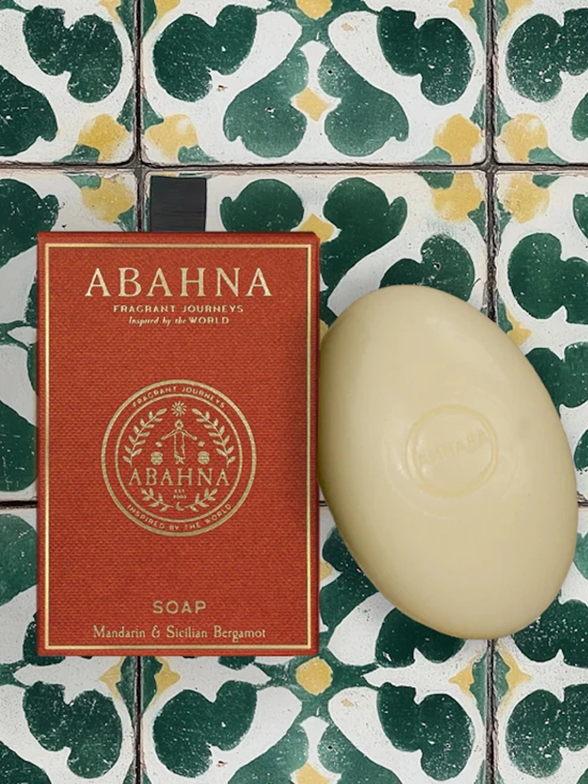 orange box and white bar of soap on green and white tile