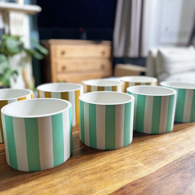 Mint and white striped pots on a table.