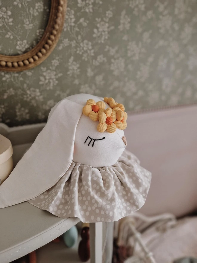 Rabbit Head Wall Mount, a cotton rabbit head wall decoration in a child's bedroom accompanied by other bedroom accessories. 