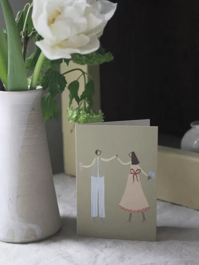a cute couple dancing illustration on a greetings card