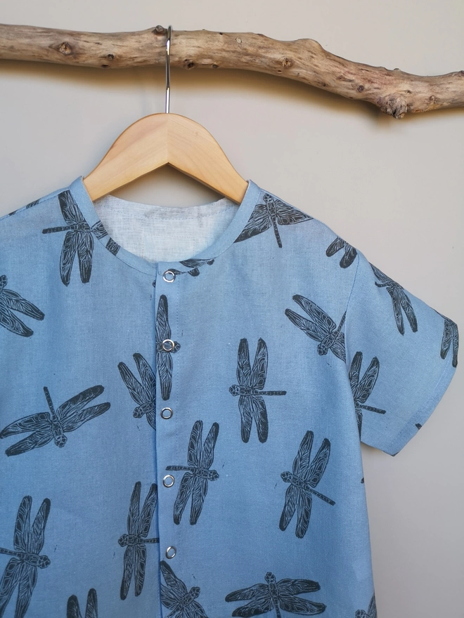 A lightweight soft pink popper down front shirt with charcoal grey Dragonfly print and short sleeves.