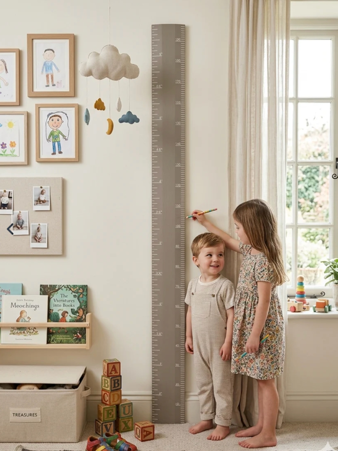 Wooden Height Chart. A large ruler height chart in Charleston Grey leaning against a child’s wall.