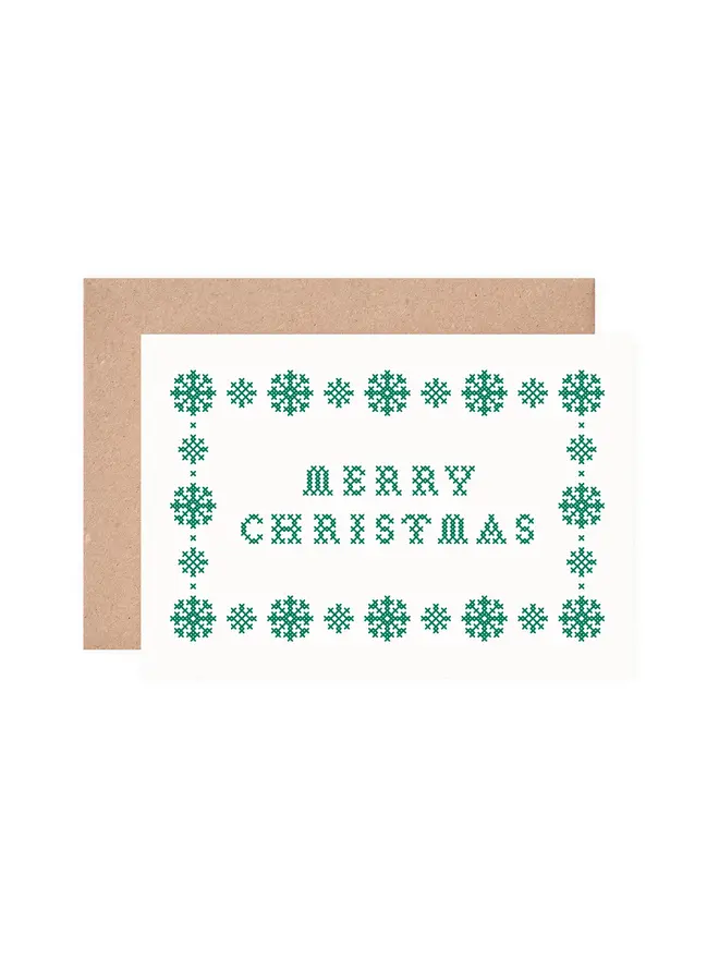 cutout of a christmas card screen printed with a green cross stitch design