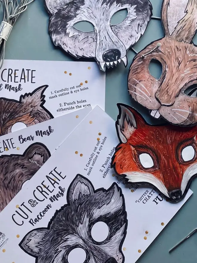 Cut And Create Forest Animals Children’s Masks Kit, laying on a blue table. 
