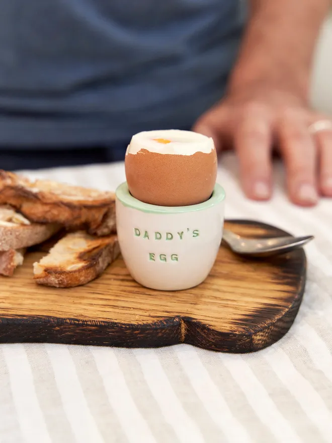 Daddy's Egg. Handmade Ceramic Egg Cup,  ceramic egg cup sitting on a wooden surface. 