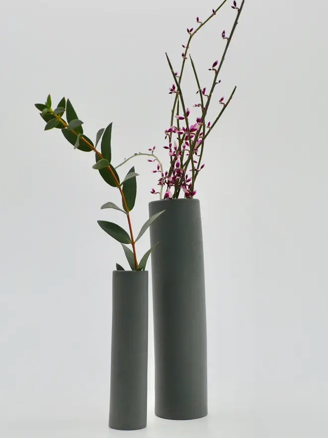 2 grey stem vases with flowers