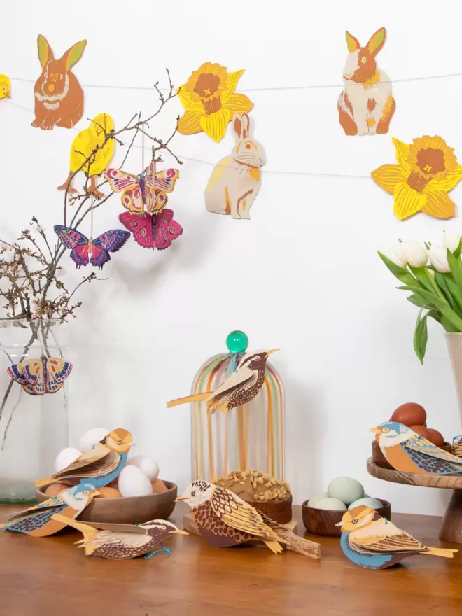 Easter display of paper birds, butterflies and rabbit and chick garland