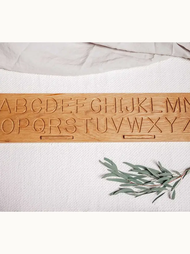 Wooden Alphabet Tracing Board Heirloom Toy, on a table. 
