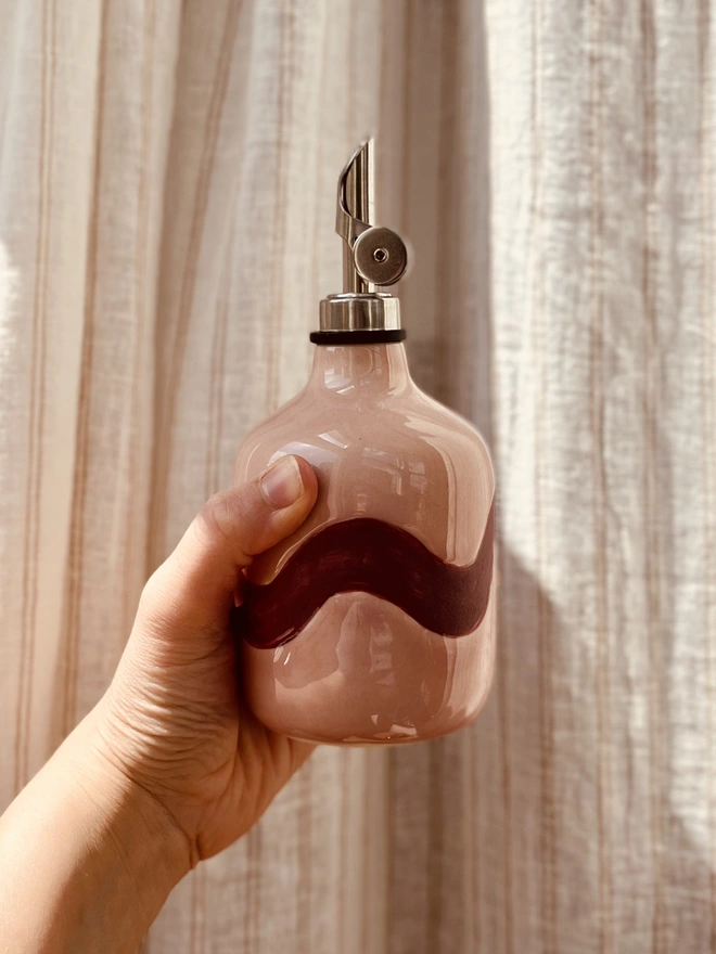 blush pink with burgundy wave oil bottle