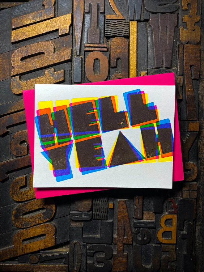 A congratulatory letterpress card using vibrant fluorescent inks the deep impression word HELL YEAH; in bold letters with a set of colourful envelopes. Perfect for exam results and graduations and other celebrations and milestones.