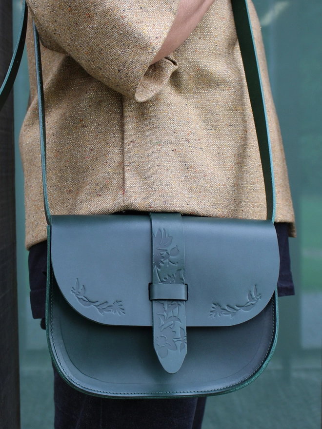 a personalised green leather shoulder bag with embossed flower details by Natthakur