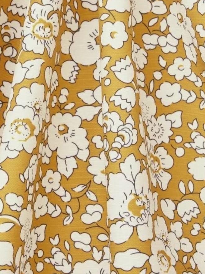 Liberty London Fringed Parasol. A parasol in fennel yellow.