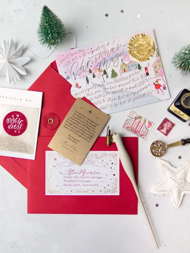 The pink certificate tucked into a red envelope with a gold foil label addressed to Alice Monroe.