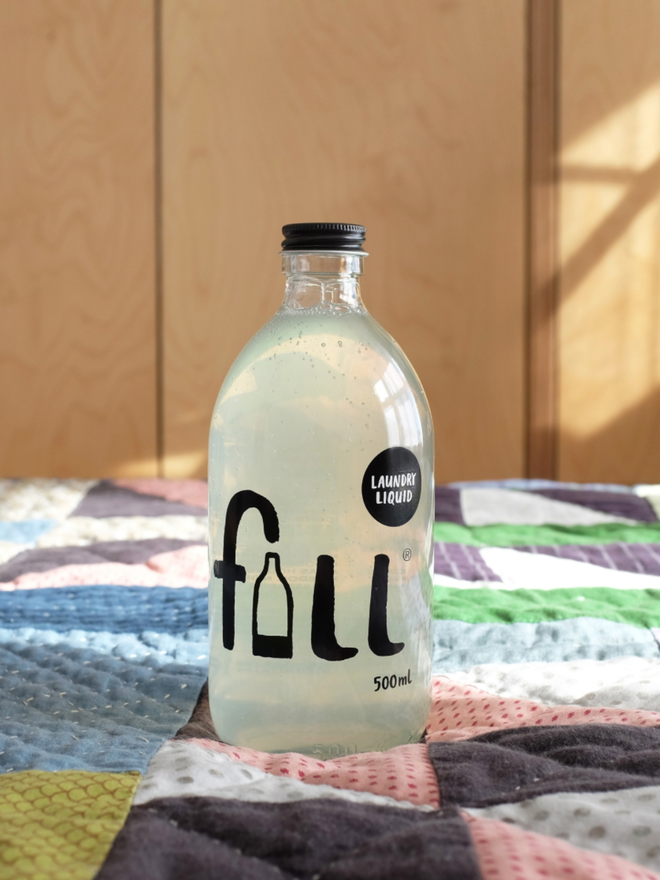 Laundry Liquid. A bottle of laundry liquid on sheets.