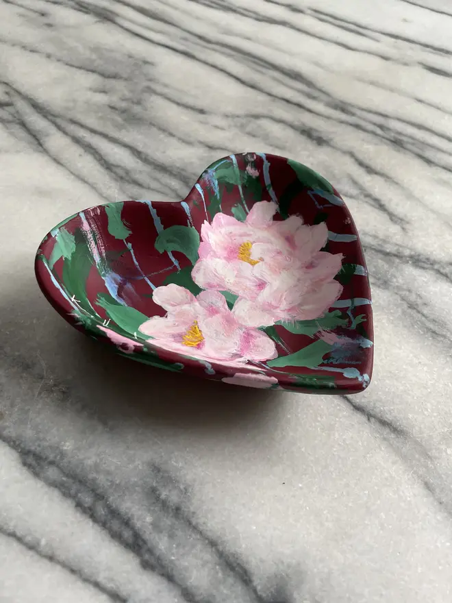 hand painted floral ceramic heart shaped keepsake dish background in a deep red and blue stripe with pink peony flowers