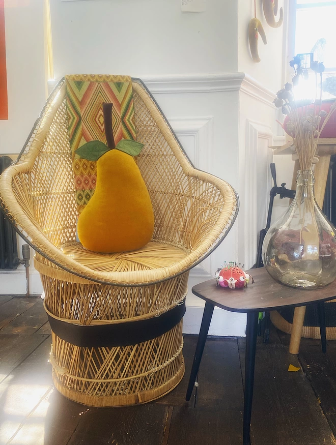 Pear cushion on a wicker chair 