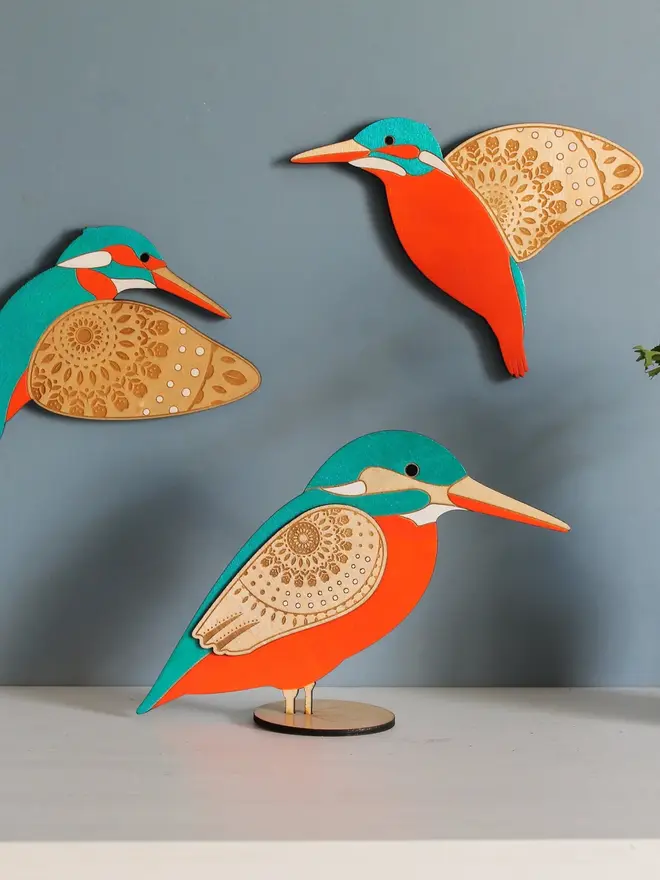 Standing Wooden Kingfisher, orange and blue wooden bird decoration standing on a platform. 