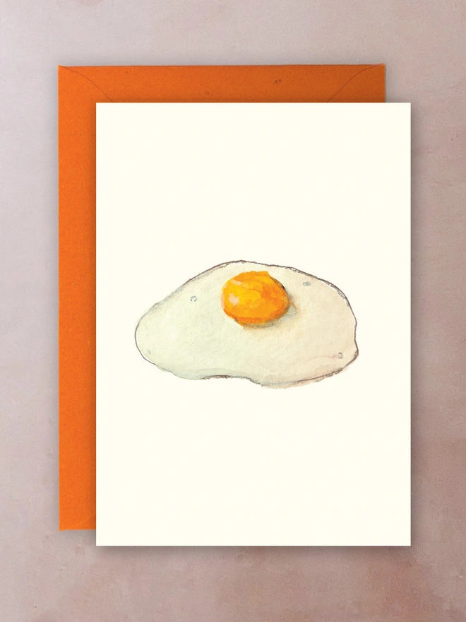 A greetings card with a watercolour of a fried egg.