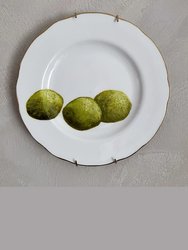 3 limes painting on plate