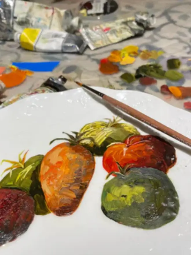 Oil Painted French Heritage Tomatoes On Antique Coalport in a studio amongst paint. 
