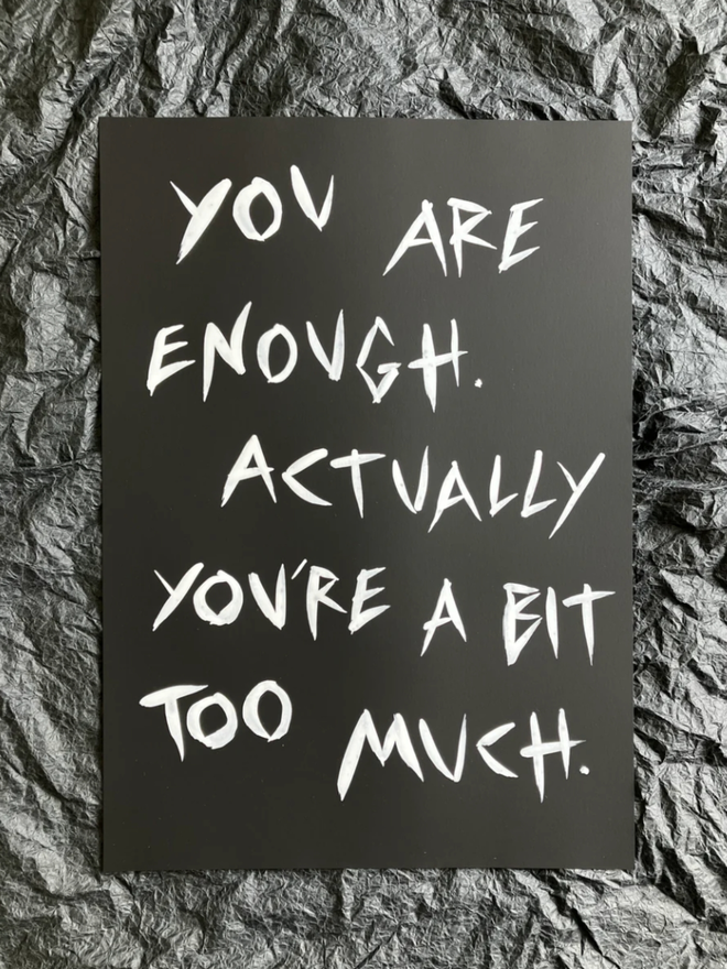 'You Are Enough' painting. White ink on black paper.