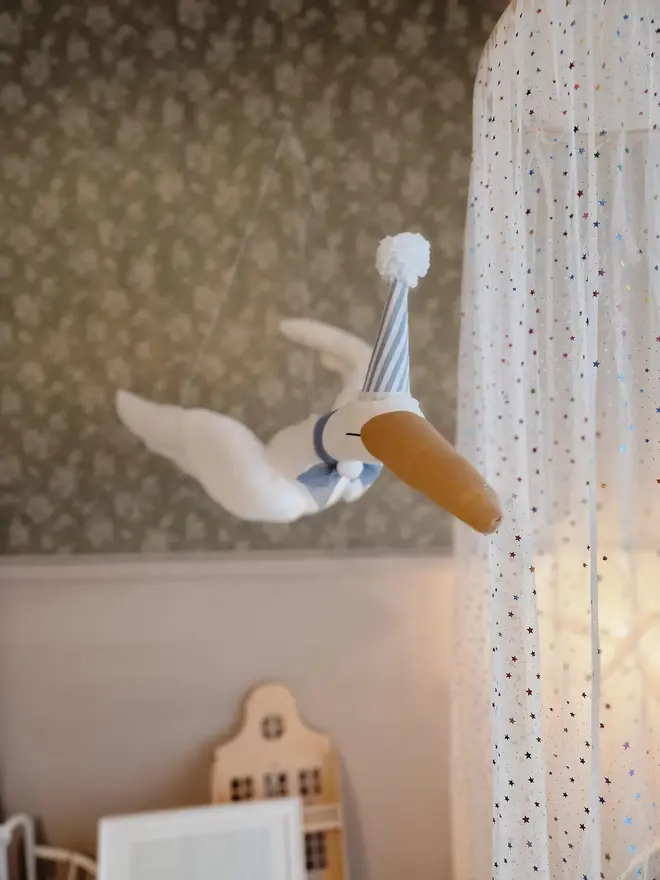 Circus Swan Hanging Decoration, a hanging swan decoration suspended in a child's bedroom. 