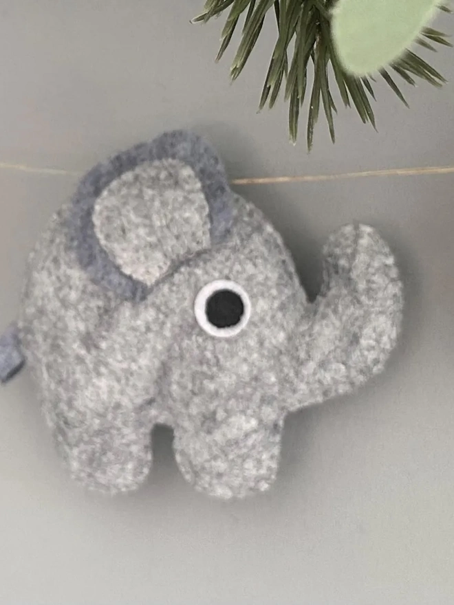 Nursery Safari Garland, a safari themed garland hanging in a child's bedroom against a grey backdrop. 