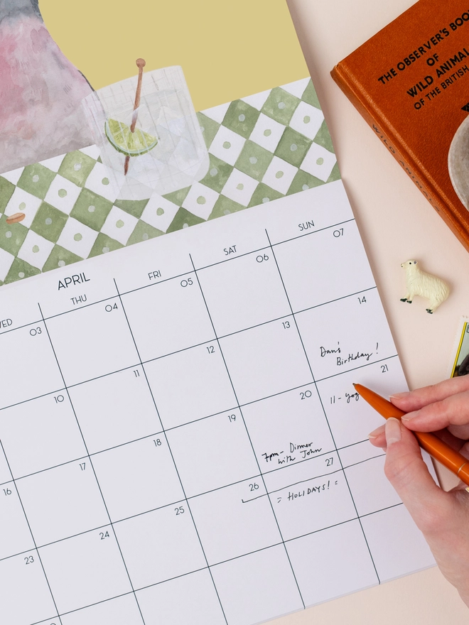 2027 calendar with a hand writing inside
