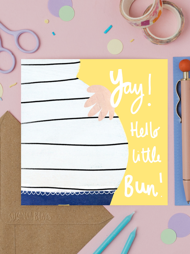 'hello little bun' illustrated new baby card. card photographed on table with assorted craft items.