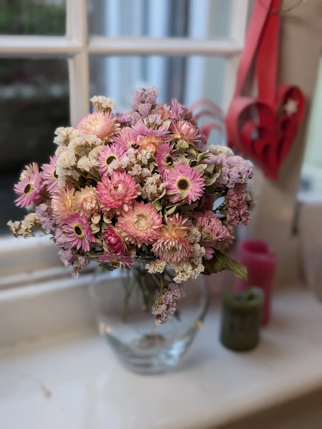 Soft pinks dried flowers in a glass vase
