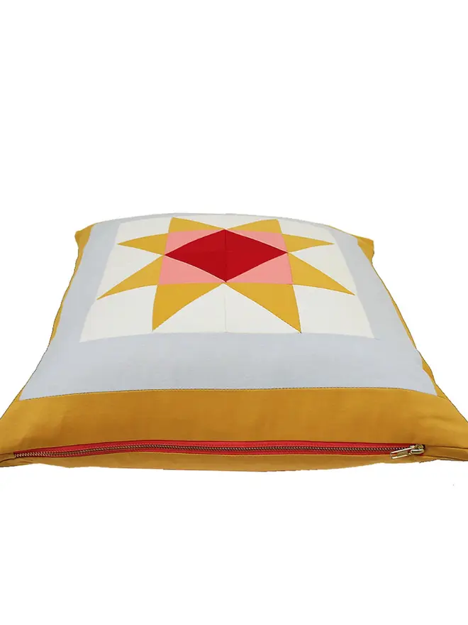 Warm Hearth Patchwork Cushion, against a white background. 