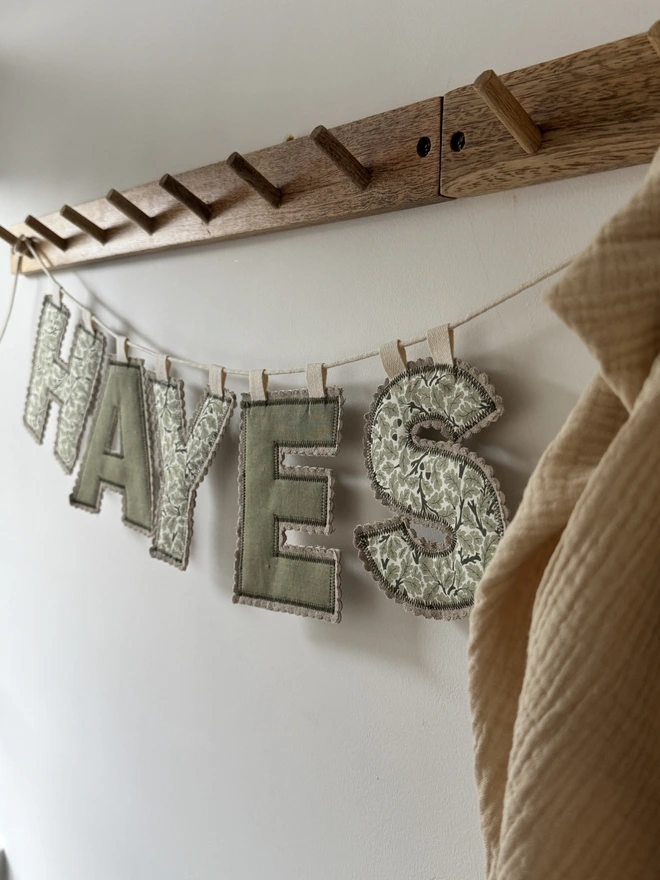 Fabric Letter Garland.  A garland in green and plain florals spelling HAYES