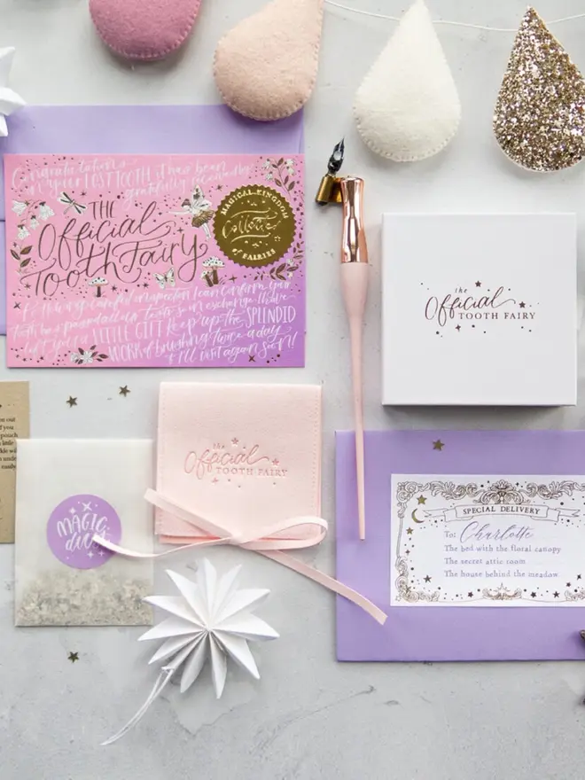 The complete pink set with notecard, blush pink pouch, gift box, Magic Dust and Charlotte's envelope. Pink, cream and glitter felt teardrops hang across the top.