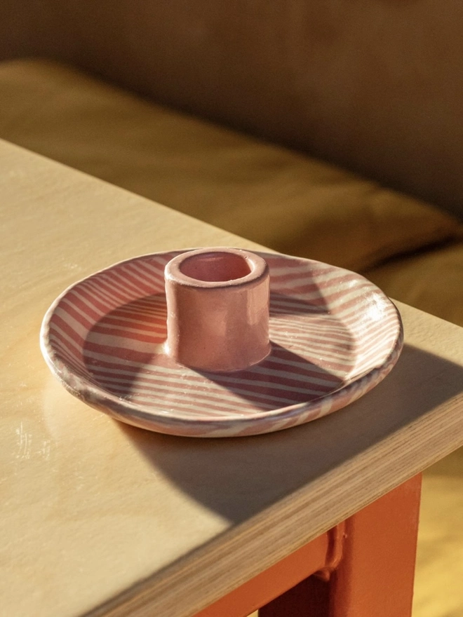 Ceramic Patterned Candlestick Holder, a colourful candlestick holder sitting on a table top surface. 