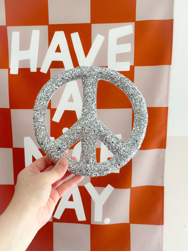 A silver glitter peace sign 