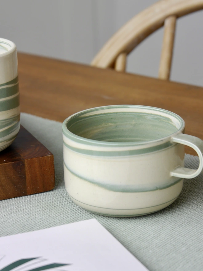 Small handmade green and white marble mug