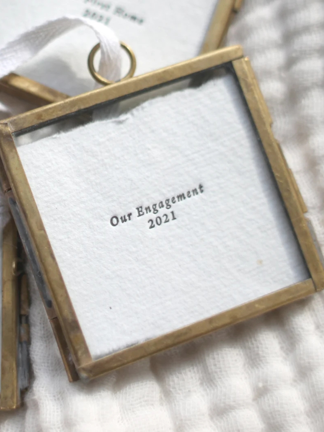 Personalised Our Engagement Hanging Frame. Letterpress printed 'our engagement' with a date on white paper in a bronze hanging frame.