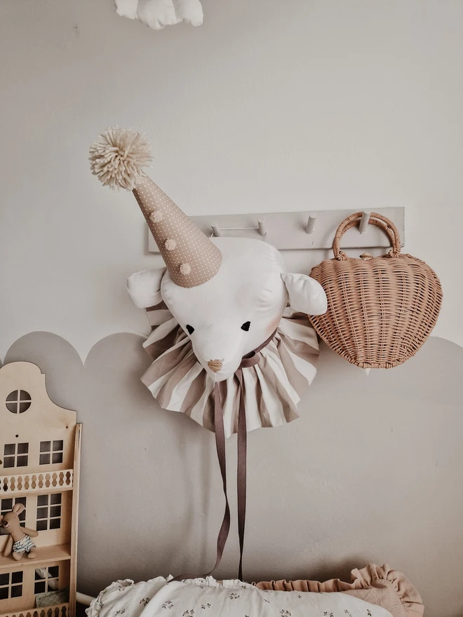 Bear Head Nursery Decoration, a bear decoration sitting against a wall in a child's decorated bedroom. 