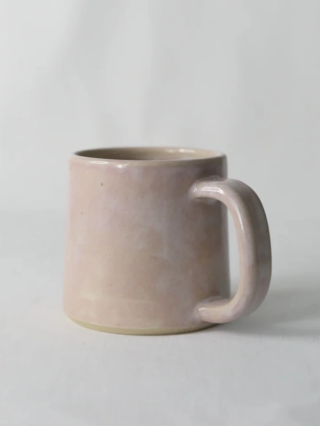 Ceramic Standard Mug, a colourful ceramic mug sitting on a plain surface against a grey backdrop. 