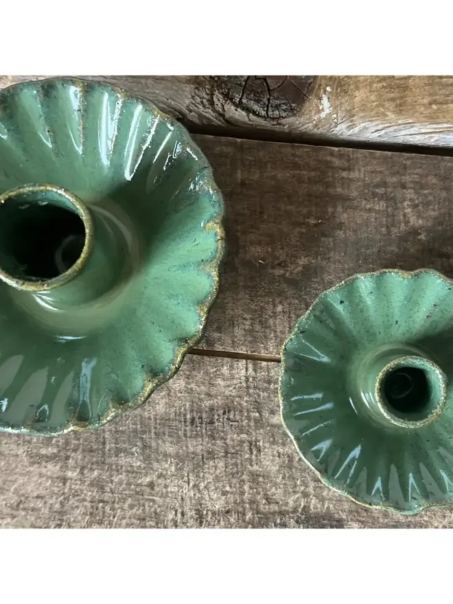 Handmade Green Ceramic Candlestick Holder, a pair of green candlestick holders sitting on a wooden surface. 