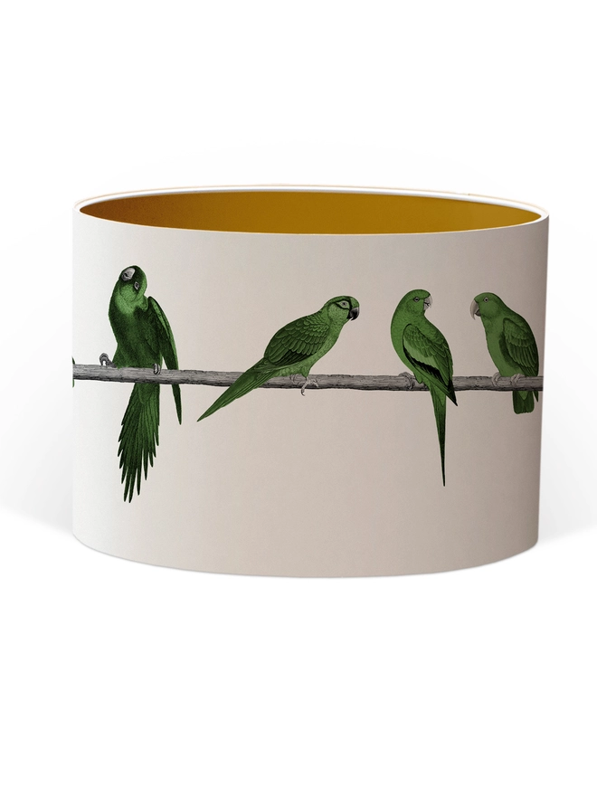 A colourful lampshade featuring a lively group of green parrots in a tropical jungle-inspired design, bringing a playful touch to home interiors.